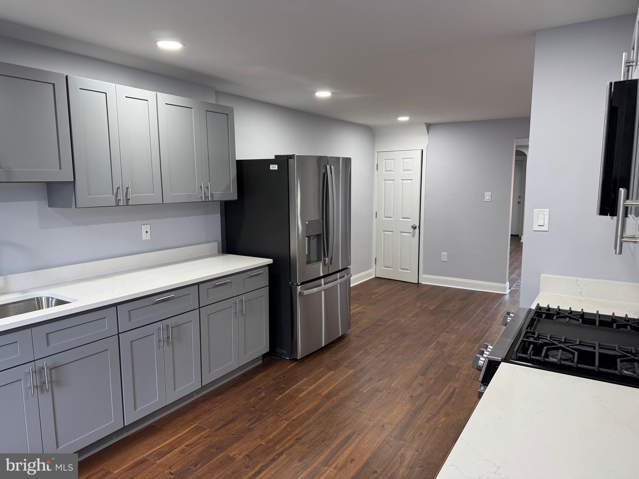 126 Richfield Road Upper Darby, PA 19082 - Photo 15 of 21 a kitchen with stainless steel appliances a refrigerator a stove and white cabinets