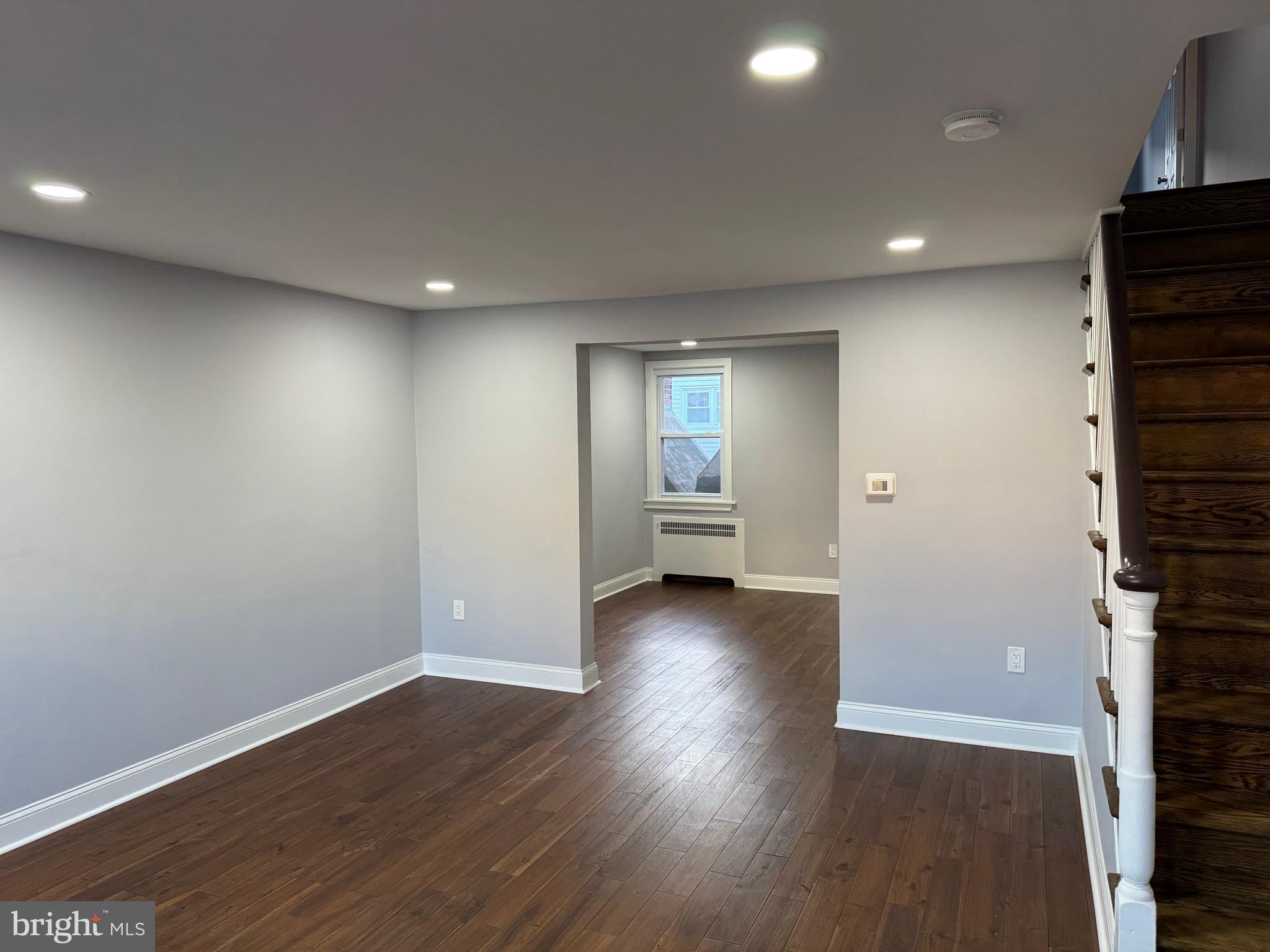 126 Richfield Road Upper Darby, PA 19082 - Photo 3 of 21 an empty room with wooden floor and windows