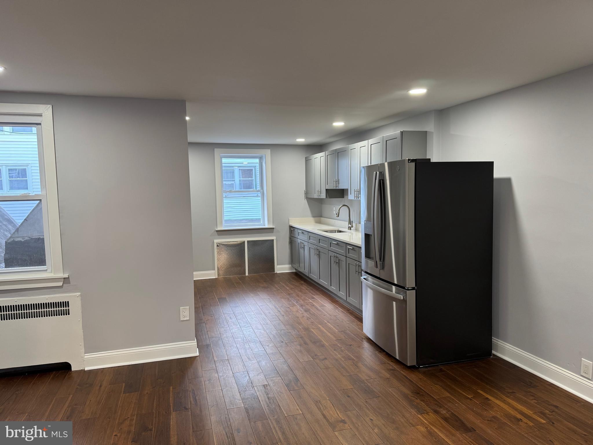 126 Richfield Road Upper Darby, PA 19082 - Photo 5 of 21 a kitchen with stainless steel appliances a refrigerator and wooden floor