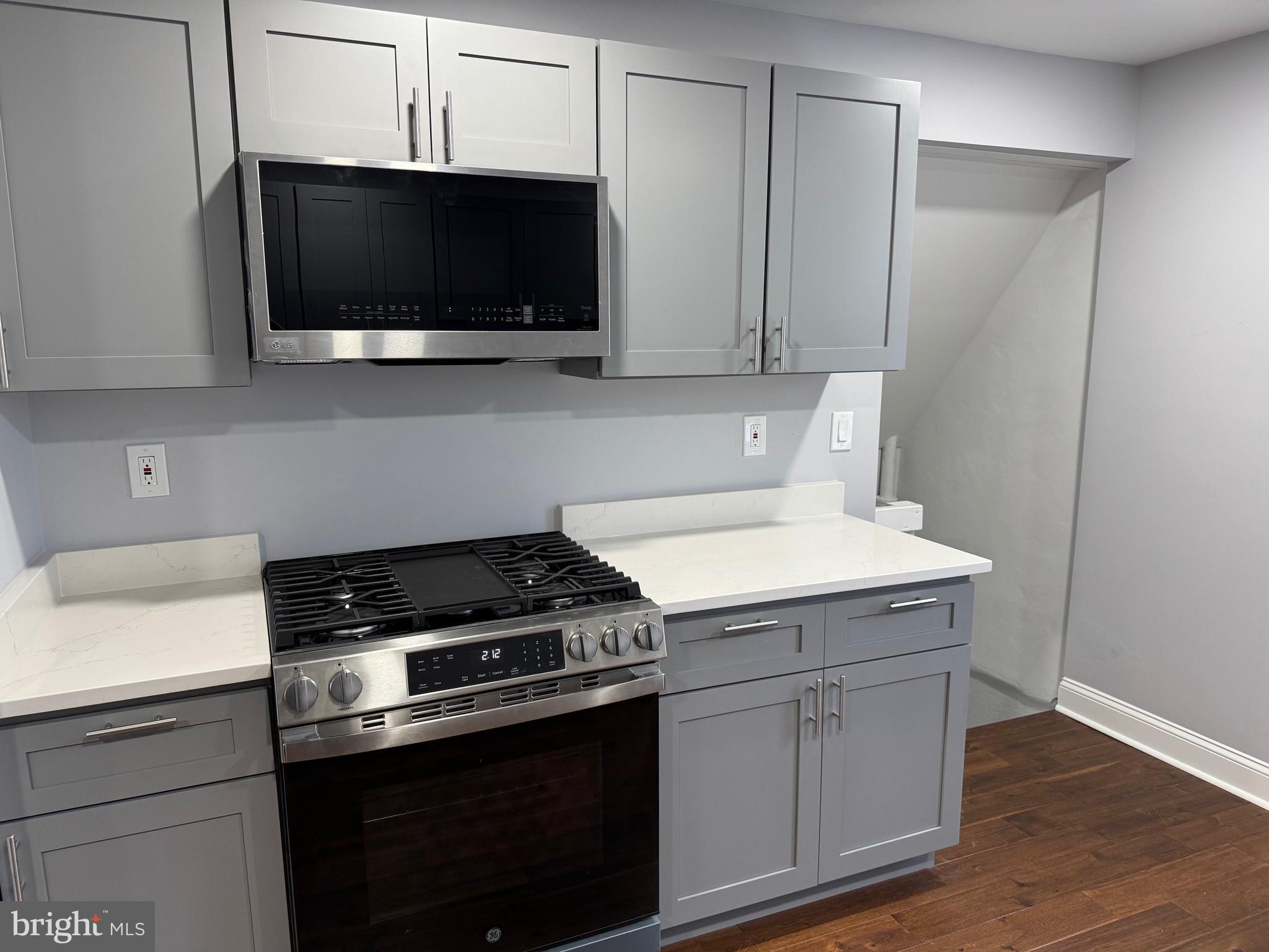 126 Richfield Road Upper Darby, PA 19082 - Photo 7 of 21 a kitchen with a stove and a microwave