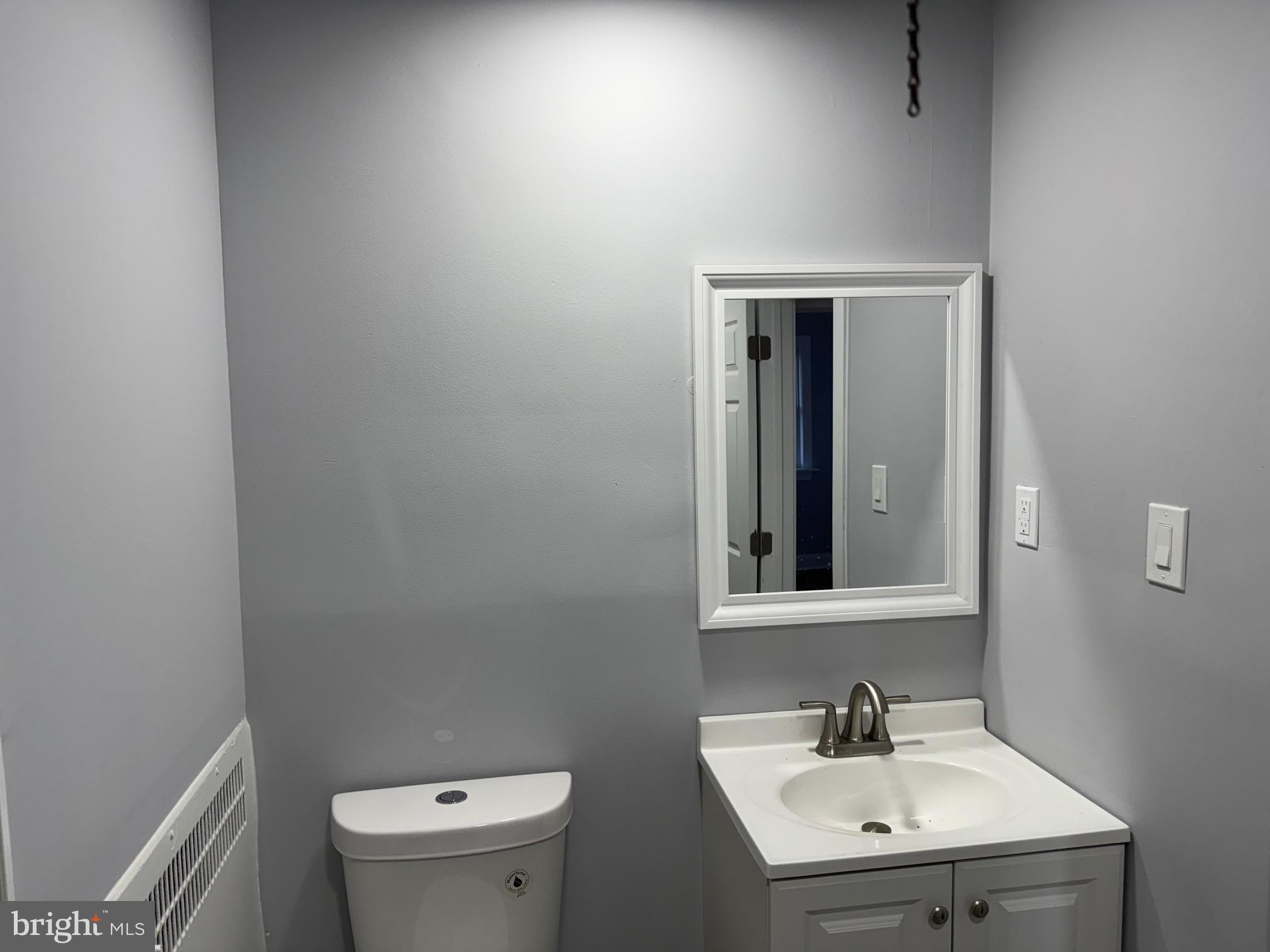 126 Richfield Road Upper Darby, PA 19082 - Photo 10 of 21 a bathroom with a sink a toilet and mirror
