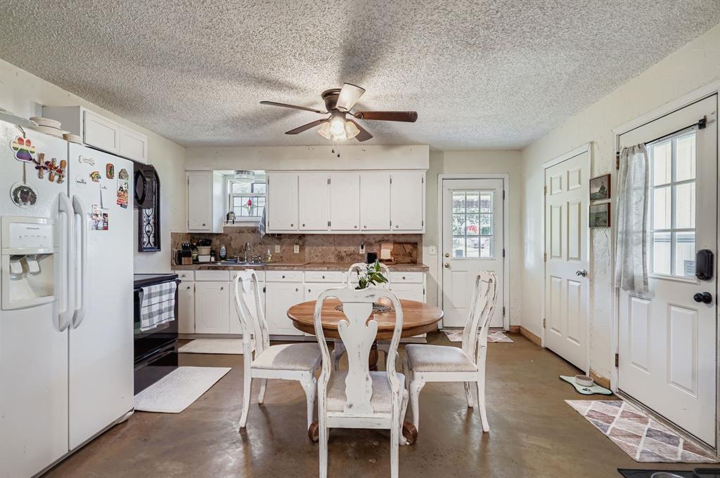 1305 Hutchins Lane Springtown, TX 76082 - Photo 4 of 23 a view of kitchen with refrigerator and wooden floor
