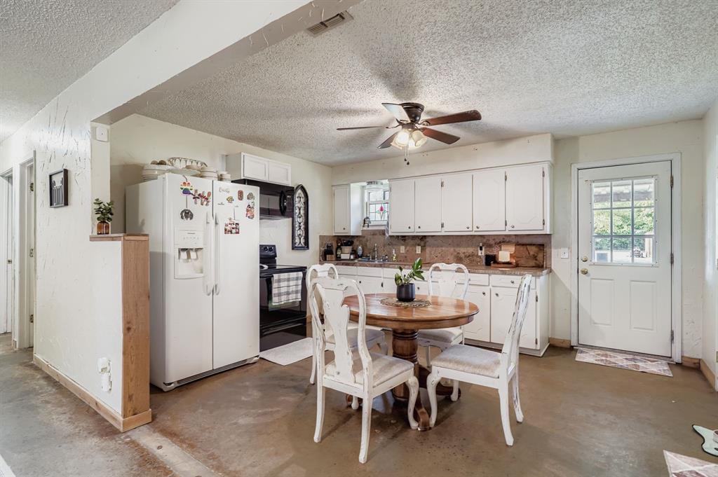 1305 Hutchins Lane Springtown, TX 76082 - Photo 6 of 23 a view of a dining room with furniture and a refrigerator