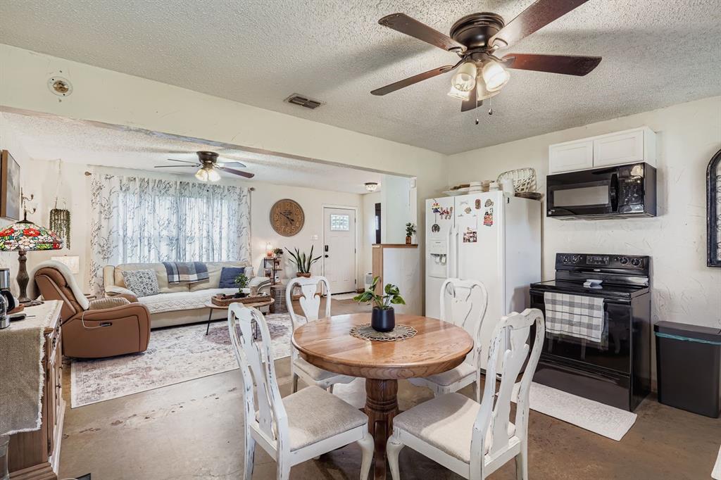 1305 Hutchins Lane Springtown, TX 76082 - Photo 7 of 23 a living room with furniture a flat screen tv and a window