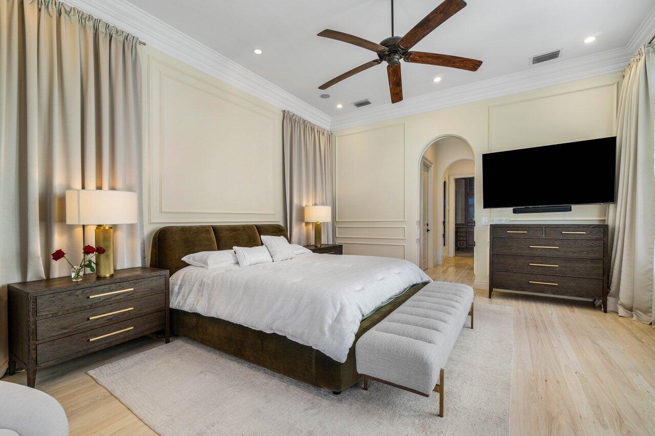 14140 Paradise Point Road Palm Beach Gardens, FL 33410 - Photo 24 of 148 a bedroom with a bed and a flat screen tv