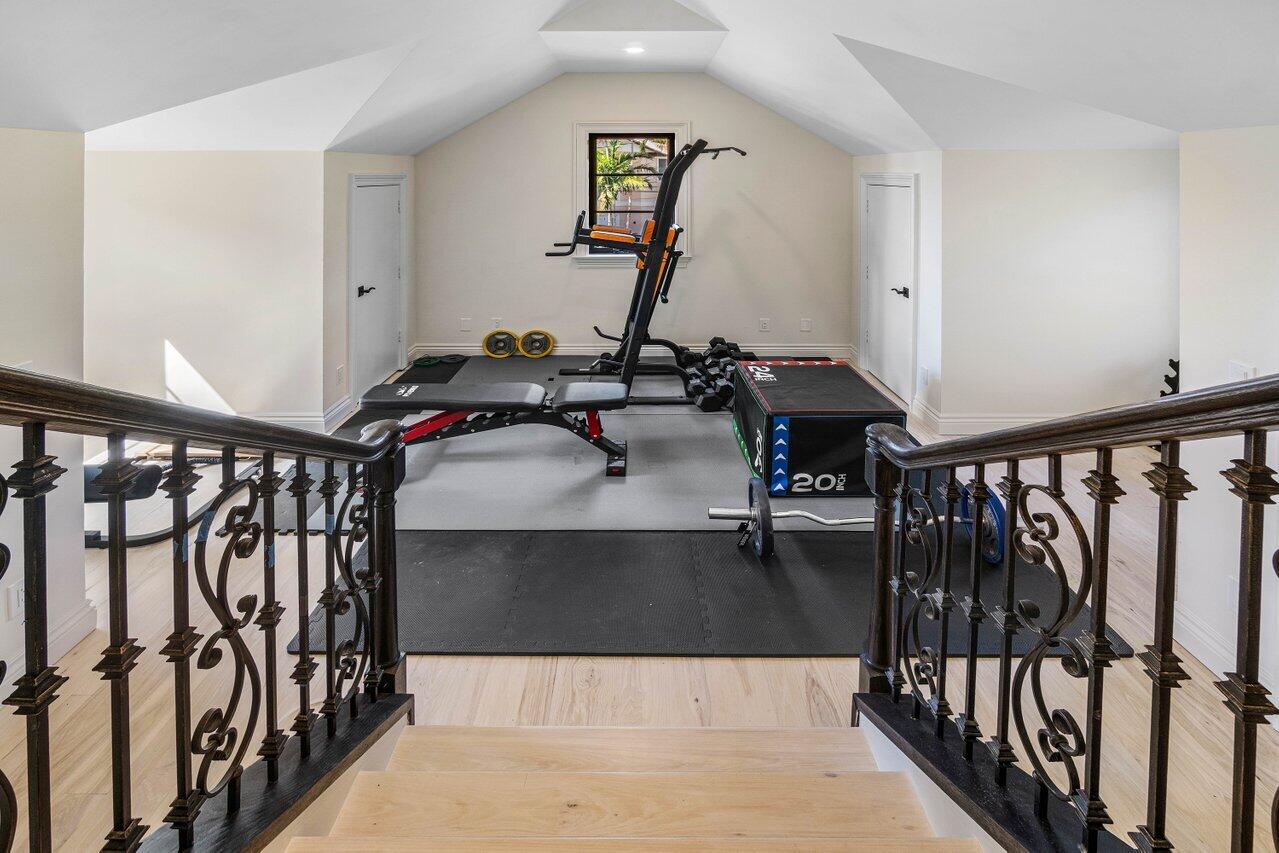 14140 Paradise Point Road Palm Beach Gardens, FL 33410 - Photo 35 of 148 a view of a hallway with wooden floor and staircase