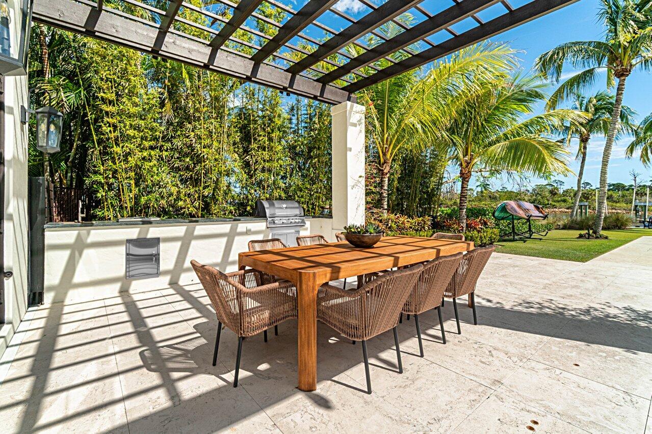 14140 Paradise Point Road Palm Beach Gardens, FL 33410 - Photo 42 of 148 a patio with yard glass top table and chairs