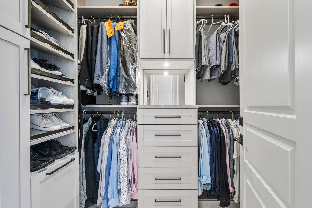 14140 Paradise Point Road Palm Beach Gardens, FL 33410 - Photo 67 of 148 a view of walk in closet with clothes and shoes