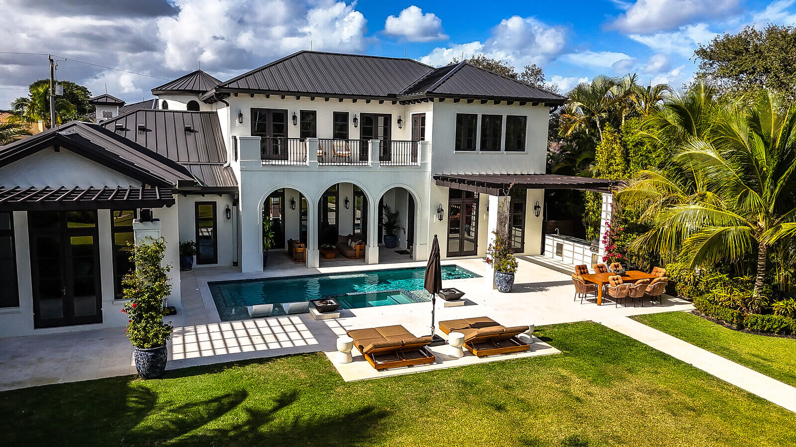 14140 Paradise Point Road Palm Beach Gardens, FL 33410 - Photo 10 of 148 a front view of a house with a yard table and chairs