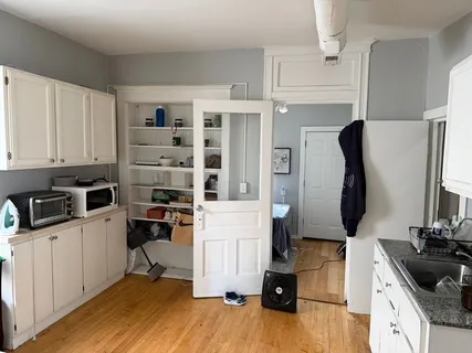 a kitchen with stainless steel appliances a stove a sink and a refrigerator