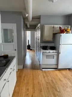a kitchen with stainless steel appliances a stove a refrigerator and a sink