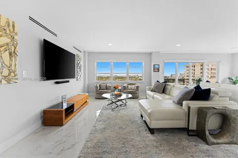 a large kitchen with stainless steel appliances kitchen island granite countertop a refrigerator and a stove top oven