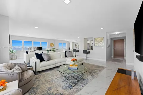 a dining room with furniture and a kitchen view