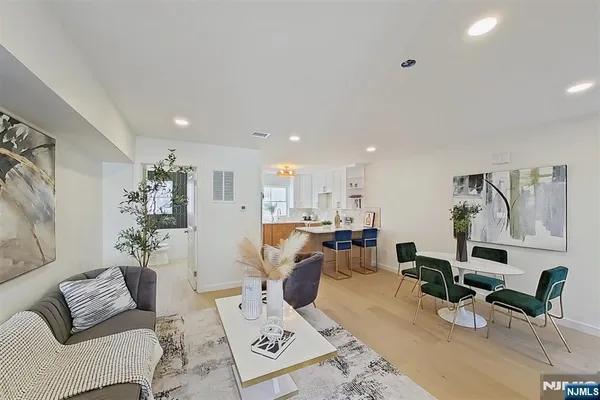 a living room with furniture and painting on the wall