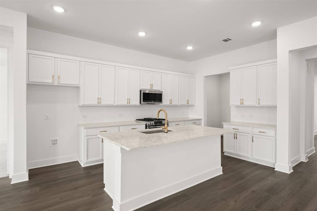 1725 Nesting Robin Lane Krum, TX 76249 - Photo 12 of 27 a kitchen with cabinets appliances and wooden floor