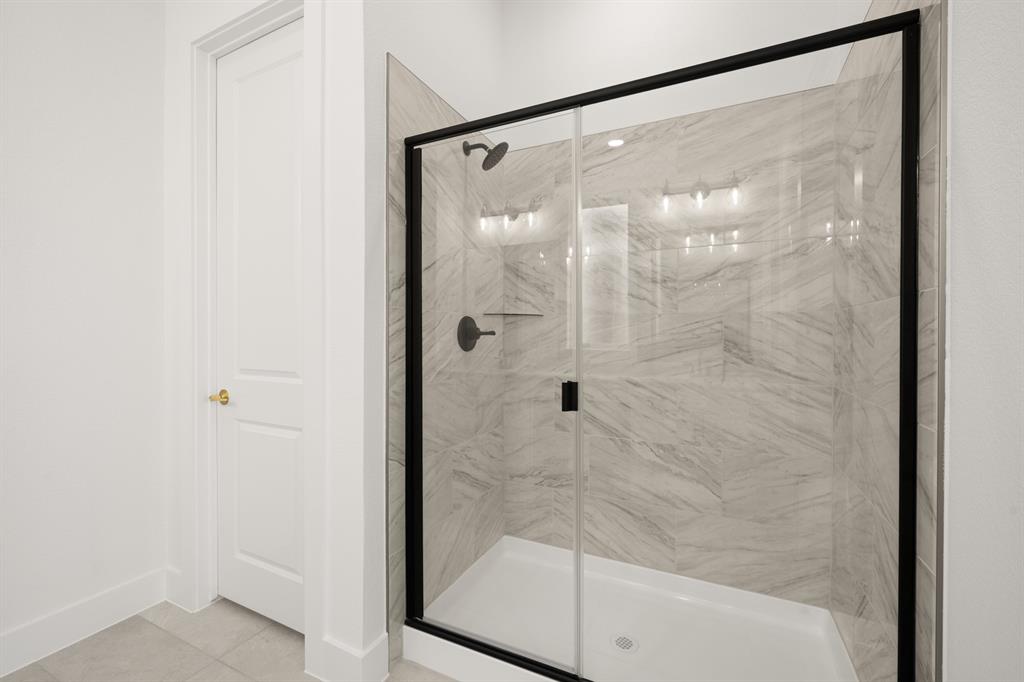 1725 Nesting Robin Lane Krum, TX 76249 - Photo 20 of 27 a bathroom with a glass shower door