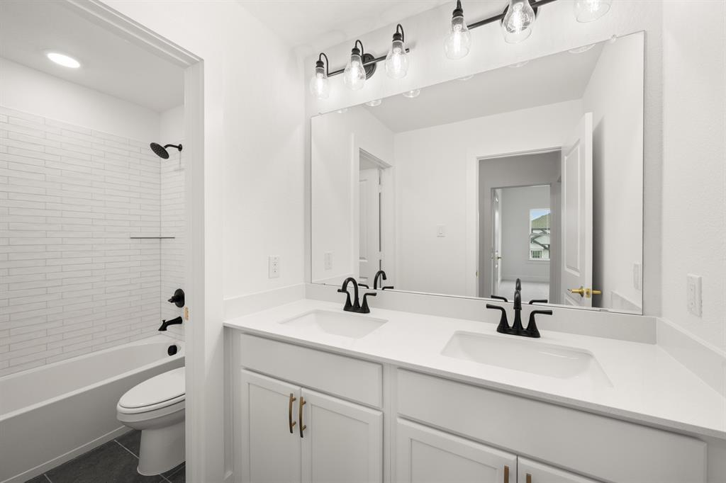 1725 Nesting Robin Lane Krum, TX 76249 - Photo 27 of 27 a bathroom with a double vanity sink toilet mirror and bathtub
