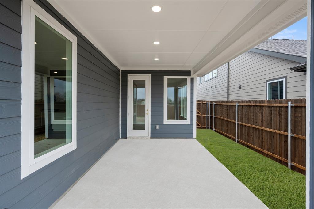 1725 Nesting Robin Lane Krum, TX 76249 - Photo 5 of 27 a view of a backyard with floor to ceiling window and wooden floor