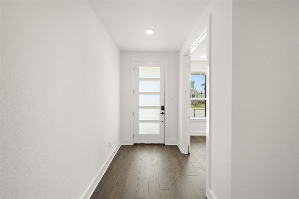 1725 Nesting Robin Lane Krum, TX 76249 - Photo 6 of 27 a view of an empty room with wooden floor and a window