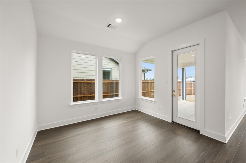 1725 Nesting Robin Lane Krum, TX 76249 - Photo 10 of 27 an empty room with wooden floor and windows