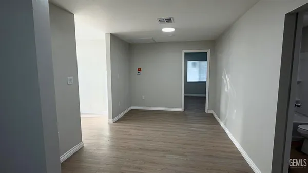 a view of a hallway with wooden floor