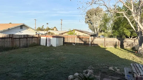 a view of a house with a yard and sitting area