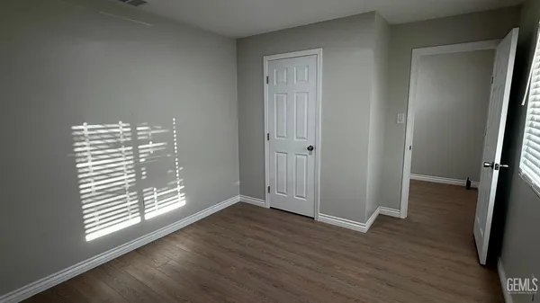 a view of wooden floor and windows in a room