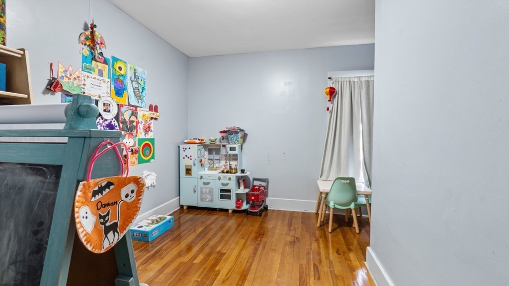 6 Crescent Street, Unit 6 Northbridge, MA 01588 - Photo 17 of 24 a utility room with toys and wooden floor