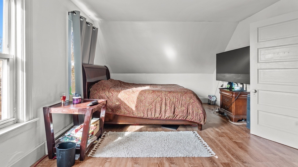 6 Crescent Street, Unit 6 Northbridge, MA 01588 - Photo 18 of 24 a bedroom with a bed next to a window with the outer view