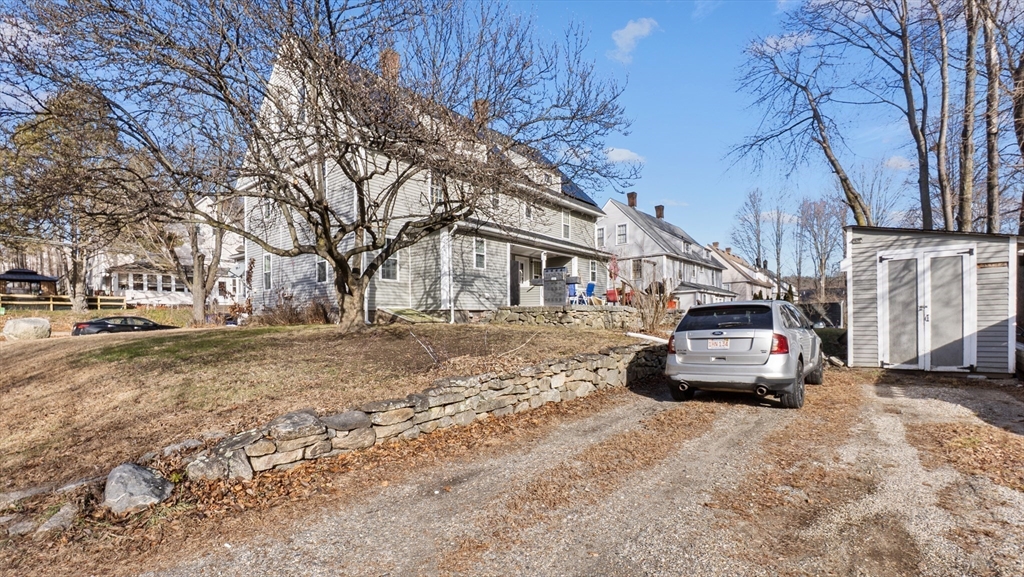 6 Crescent Street, Unit 6 Northbridge, MA 01588 - Photo 22 of 24 a car parked in front of white house