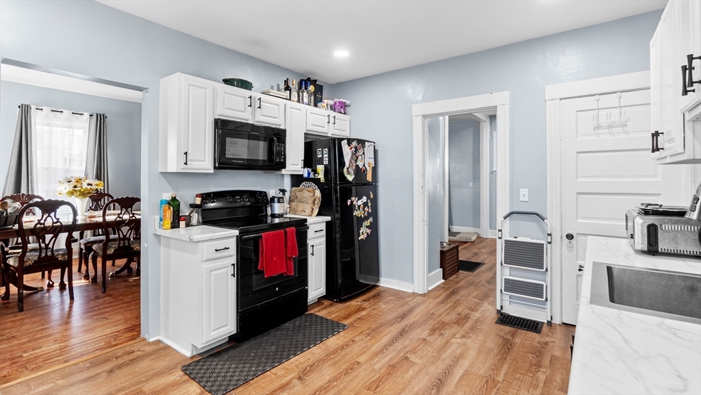 6 Crescent Street, Unit 6 Northbridge, MA 01588 - Photo 4 of 24 a kitchen with a refrigerator cabinets and wooden floor