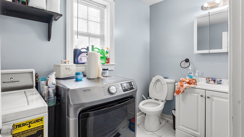 6 Crescent Street, Unit 6 Northbridge, MA 01588 - Photo 5 of 24 a bathroom with a toilet sink and mirror