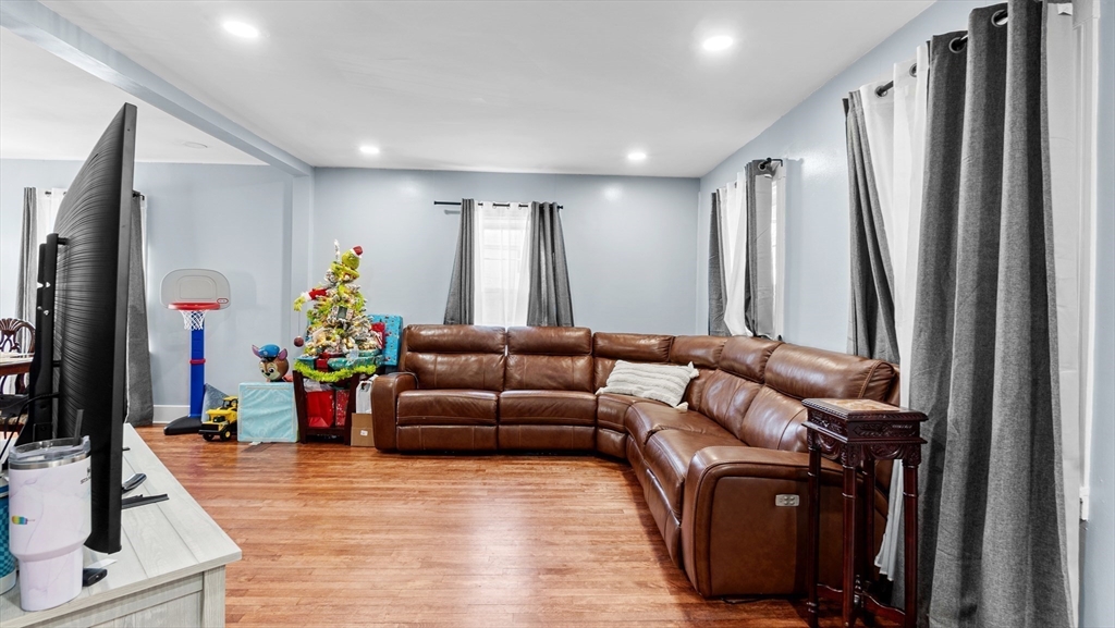 6 Crescent Street, Unit 6 Northbridge, MA 01588 - Photo 7 of 24 a living room with furniture and a flat screen tv