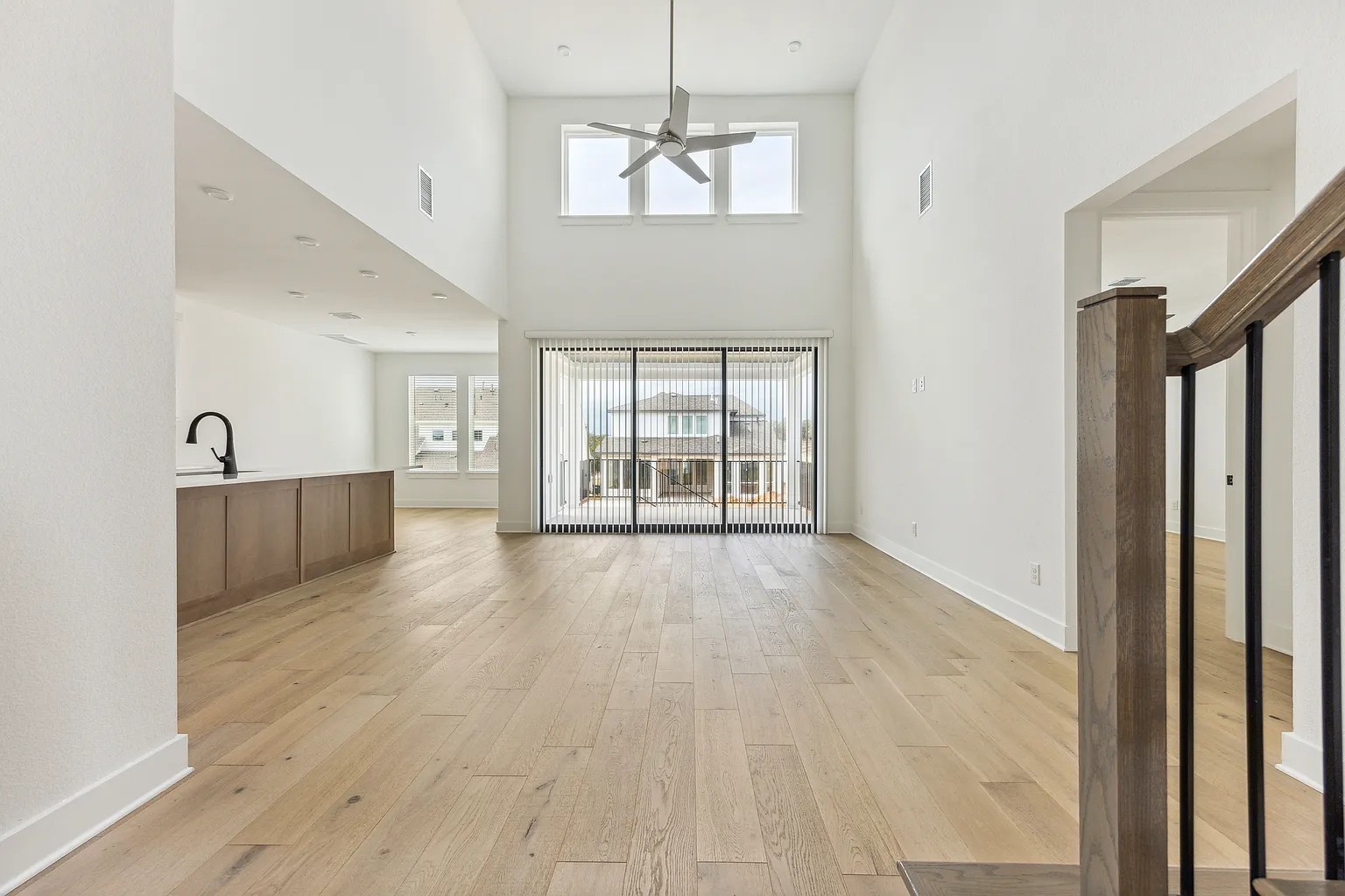 1909 Varese Path Leander, TX 78641 - Photo 8 of 40 A grand, naturally illuminated living area featuring soaring ceilings and pristine hardwood flooring.