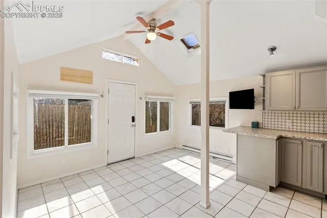 a living room with a flat screen tv and white walls