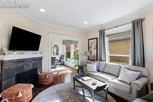 a living room with furniture a fireplace and a flat screen tv