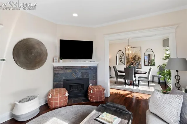 a living room with furniture a fireplace and a flat screen tv