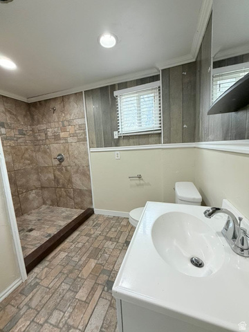 2491 Highway 89, Unit 114 Pleasant View, UT 84404 - Photo 10 of 18 Full bath with brick patterned flooring, a stall shower, vanity, and ornamental molding