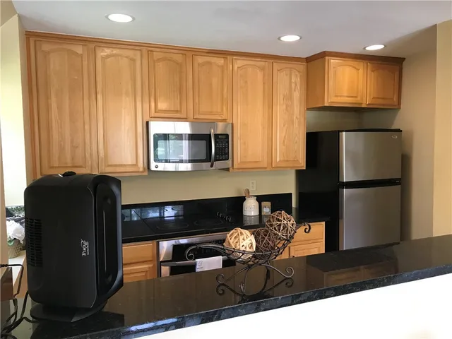 a kitchen with a refrigerator and a microwave