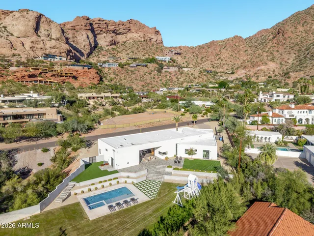 a living room with furniture a large window and wooden floor