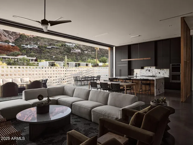 a dining room with furniture a rug and a large window