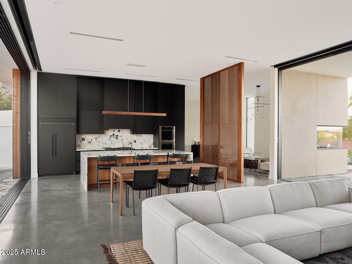 4905 East White Gates Drive Phoenix, AZ 85018 - Photo 7 of 11 a living room with furniture kitchen view and a large window