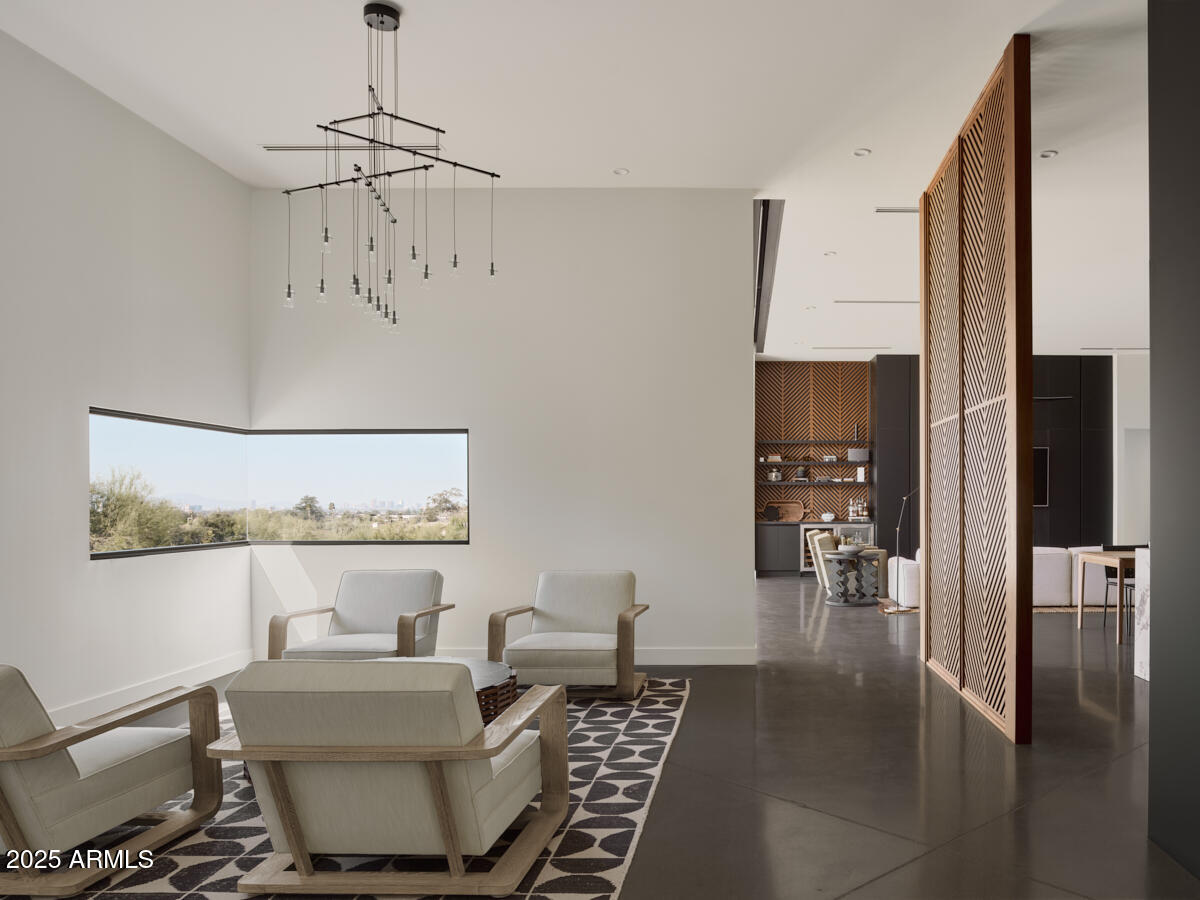 4905 East White Gates Drive Phoenix, AZ 85018 - Photo 8 of 11 a living room with furniture and a chandelier
