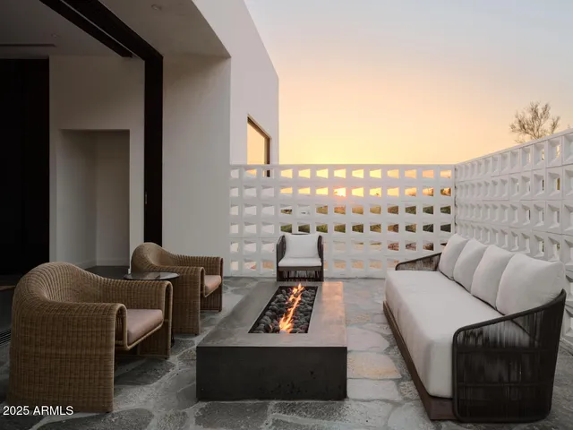 a living room with furniture a rug and a fireplace