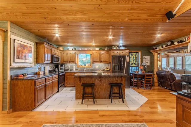 a kitchen with lots of counter top space and furniture
