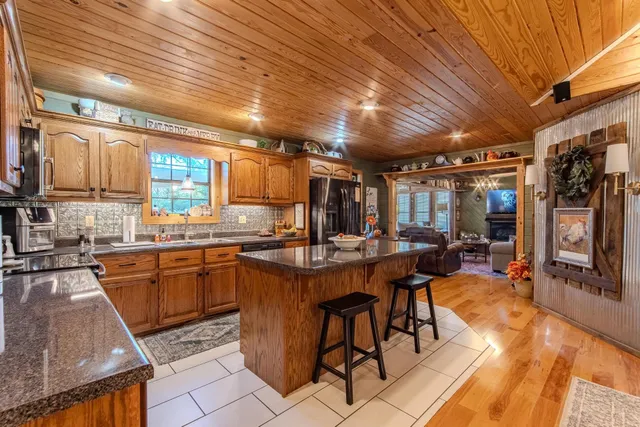 a kitchen with stainless steel appliances granite countertop a refrigerator and a stove top oven