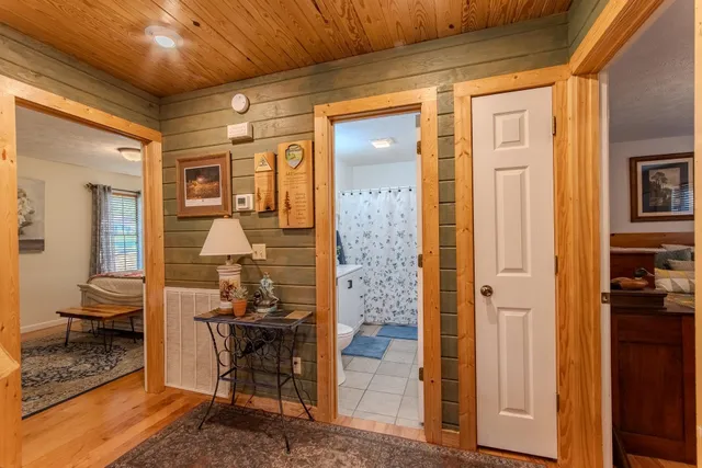 a bathroom with a granite countertop sink a toilet and a shower