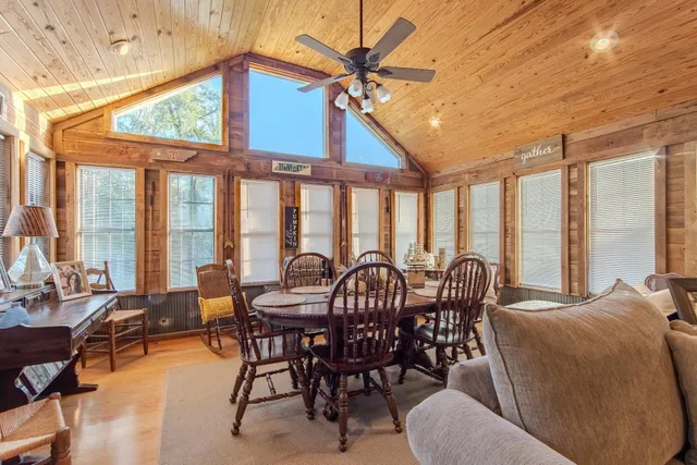 a dining room with furniture wooden floor and a potted plant