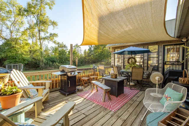 a living room with patio furniture and a fireplace