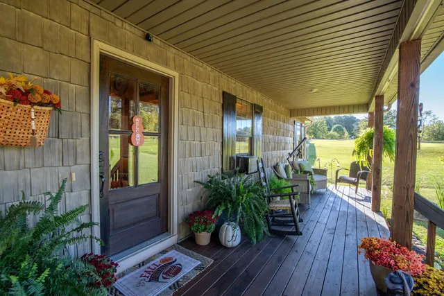 a balcony with chairs and wooden floor